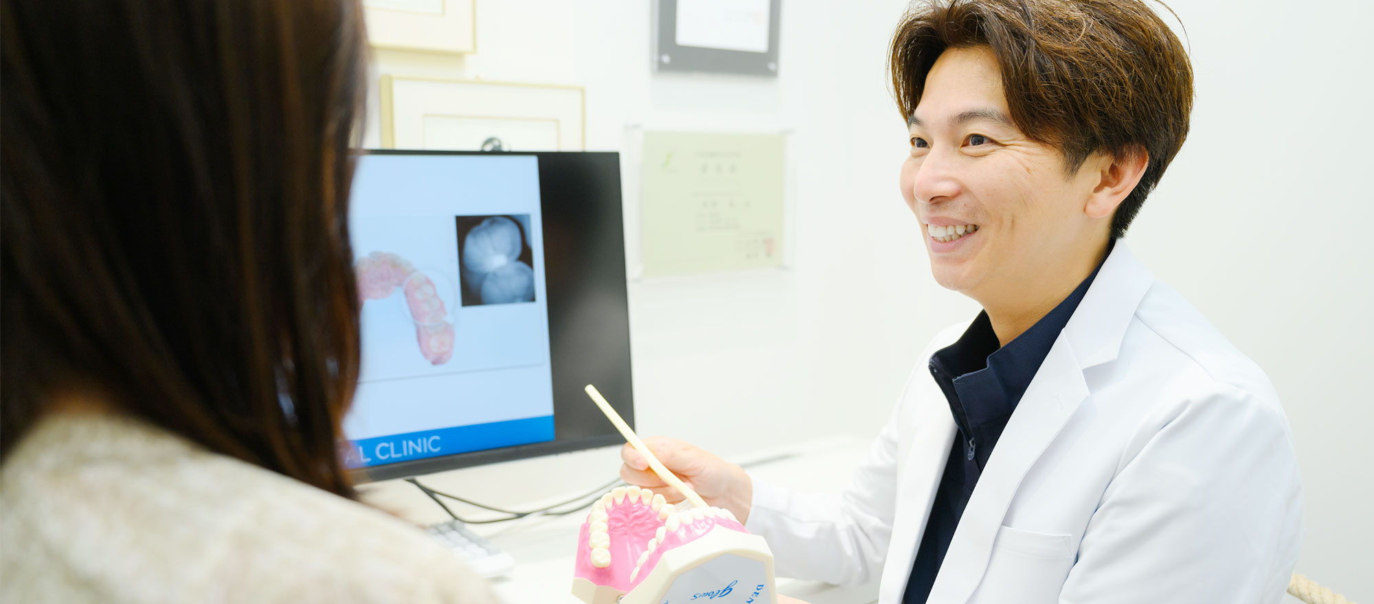 模型を使って患者様に説明する歯科医師